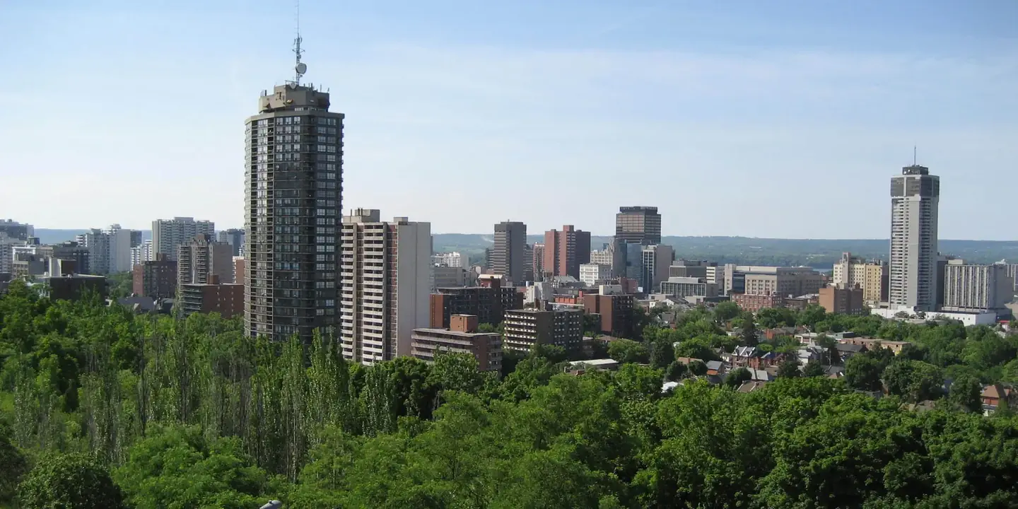 Hamilton, Ontario skyline above a wooded escarpment