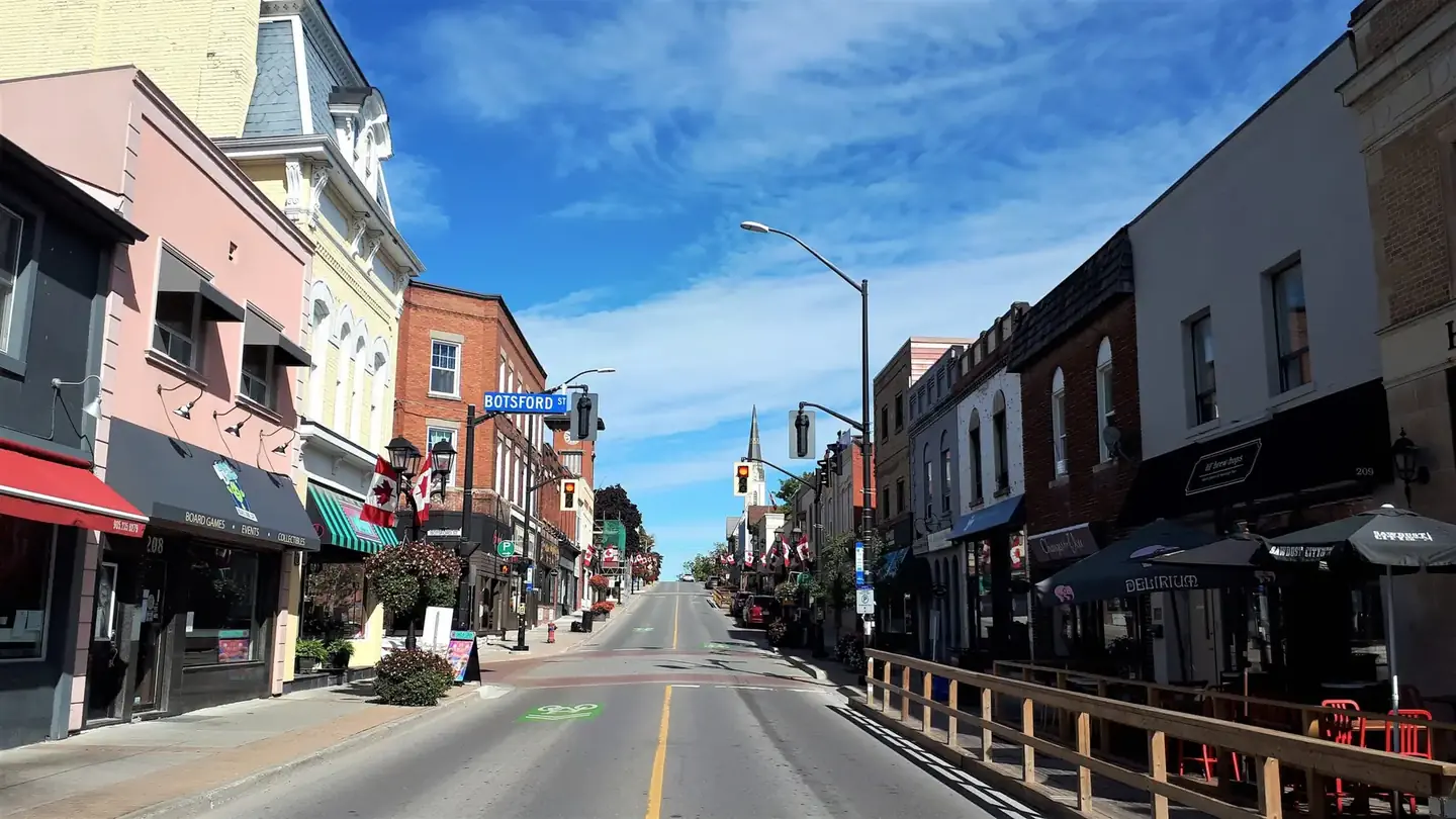 Main street with shops and parked cars in downtown Newmarket